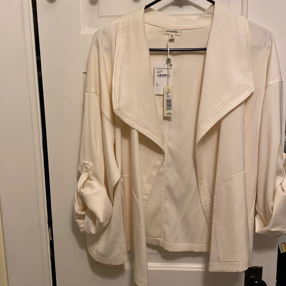 Light cream colored jacket. 98% polyester and 2% spandex machine washable. NWT